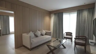 a living room with a couch and a table at RITZ AVENUE LUXURY HOTEL in Mahe