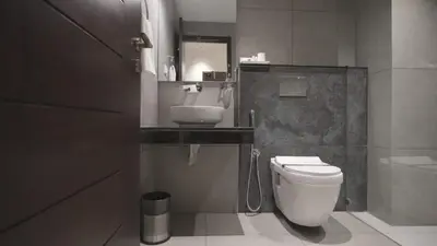 a bathroom with a toilet and a sink at RITZ AVENUE LUXURY HOTEL in Mahe