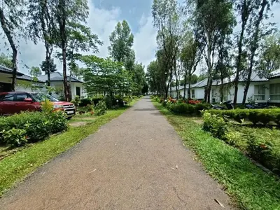 a dirt road in a residential neighborhood with houses at Spicy Nest Resort in Pinangode