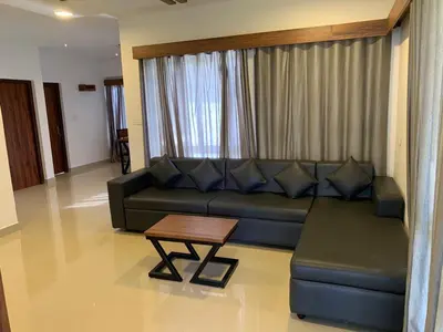 a living room with a couch and a coffee table at Spicy Nest Resort in Pinangode