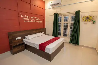 a bedroom with a bed with a sign on the wall at San Unik Homestay in Nilambūr