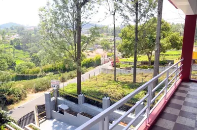a balcony with a view of a street at Franc Villa - Kothagiri in Kotagiri
