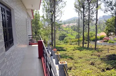 a balcony of a house with a view of a valley at Franc Villa - Kothagiri in Kotagiri