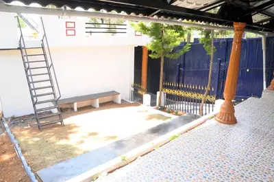 a ladder and a bench sitting on a patio at Franc Villa - Kothagiri in Kotagiri