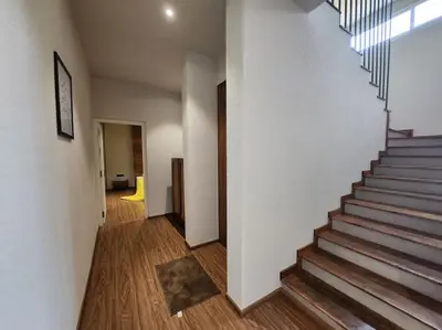 a hallway with a staircase in a house at Gulzar 2BHK Service Apartment, kannur in Kannur