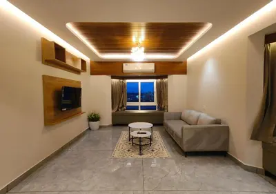 a living room with a couch and a table at Mayo Suites in Palakkad