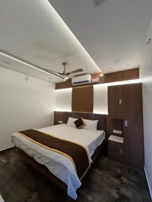 a bedroom with a large bed and a ceiling at The Tendoinn in Pollāchi