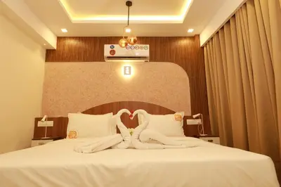 a hotel room with a bed with white towels on it at Liwa Tower Hotel & Business Center in Kunnamkulam