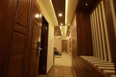 a hallway with a door leading to a room at Liwa Tower Hotel & Business Center in Kunnamkulam
