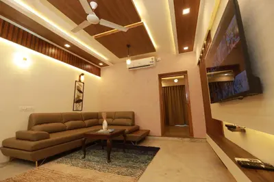 a living room with a couch and a table at Liwa Tower Hotel & Business Center in Kunnamkulam