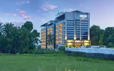 a hotel with a sign on the side of it at Noah Sky Suites in Cochin
