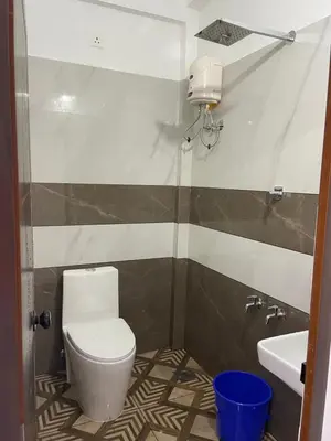 a bathroom with a toilet and a sink at New star homes in Kotamangalam