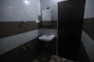 a bathroom with a sink and a mirror at New star homes in Kotamangalam