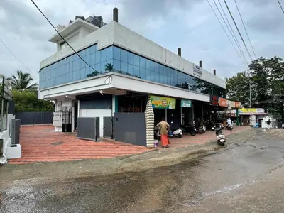 a man standing in front of a building on a street at New star homes in Kotamangalam
