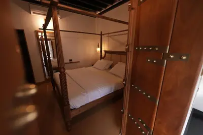 a bedroom with two bunk beds and a closet at Meleppura Heritage Homestay in Chāvakkād