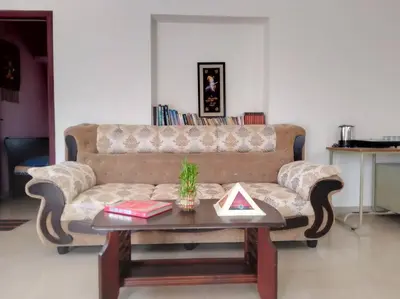 a living room with a couch and a coffee table at Aathira's 2 Bedroom house @ Heart of Coimbatore in Coimbatore