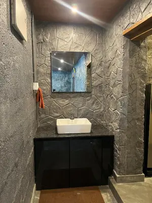 a bathroom with a sink and a mirror on a wall at Elora Resort Wayanad in Kalpetta
