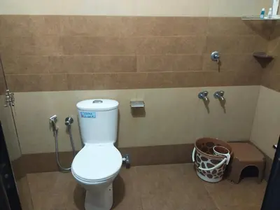 a bathroom with a toilet and a shower at The Vogue - Luxury Private Pool Villa , Athirappilly in Athirappilly