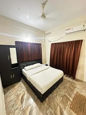 a bedroom with a large bed in a room at ZAHIR RESIDENCY in Kondotti
