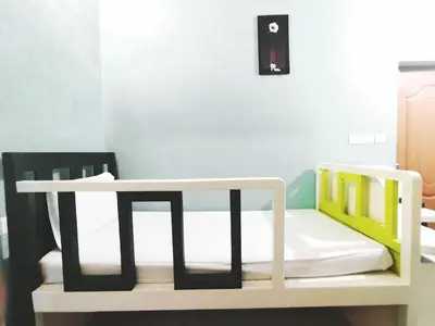a room with two bunk beds and a table at Dreamnest Residency in Kalpetta