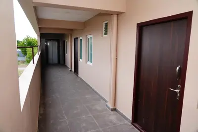 a corridor of a building with a door and a walkway at Meadow Comfort Stay in Coimbatore