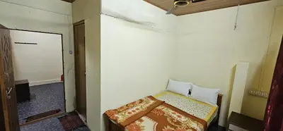 a small bedroom with a bed in a room at SPM Residency, From Live2Travel Group. in Masinagudi