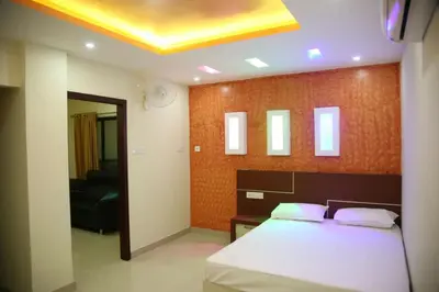 a bedroom with a bed and a yellow ceiling at City Tower Lodge in Nilambūr