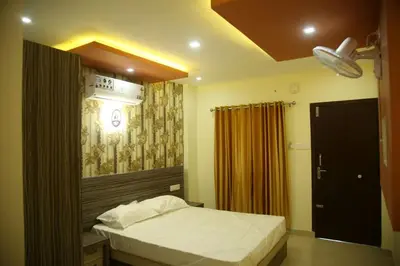 a small bedroom with a bed and a ceiling at City Tower Lodge in Nilambūr