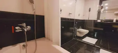a bathroom with a shower and a toilet at ASHOKA INN in Trichūr