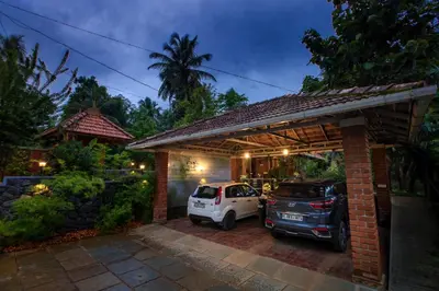 a garage with a car parked in it at Sukrutham Farmstay in Trichūr