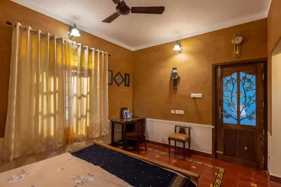 a room with a door and a table and a window at Sukrutham Farmstay in Trichūr