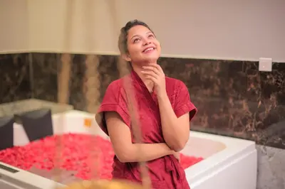 a woman standing in front of a sink at Softouch Ayurveda Village Kerala in Kizhake Chālakudi