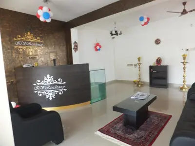a living room with a couch and a table at KV Residency in Coimbatore