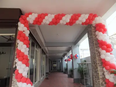 a arch with red and white balloons on a hallway at KV Residency in Coimbatore