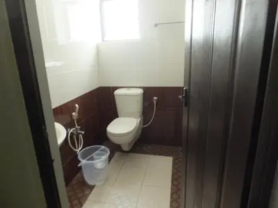 a bathroom with a toilet and a sink at KV Residency in Coimbatore