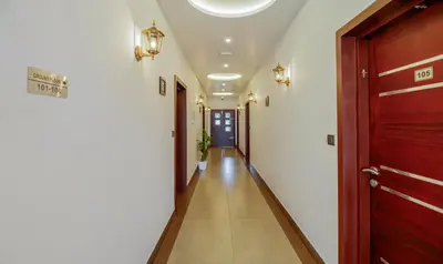 a corridor of a hallway with a door and lights at Treebo Amigos Residency in Cochin