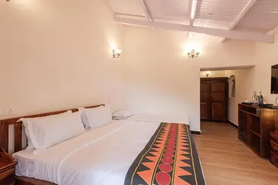 a bedroom with a large bed in a room at Ibex Resorts, Coonoor Leewood in Coonoor
