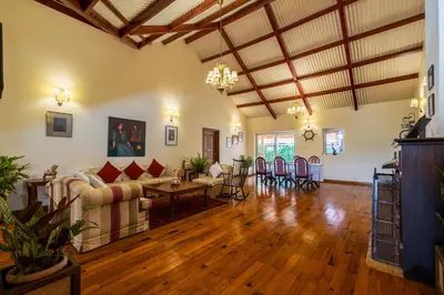 a large living room with wooden floors and ceilings at amã Stays & Trails Raven's Nest , Kotagiri in Kotagiri