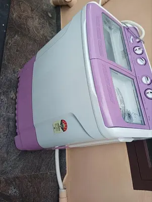 a purple and white cell phone sitting on a table at BHASURI SERVICED VILLA in Varagampadi