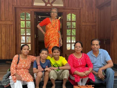 a group of people posing for a picture with a woman at Vasthyam in Kenichira