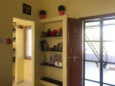 a room with a door and shelves in a room at A Sweet home Homestay Second Floor in Palani