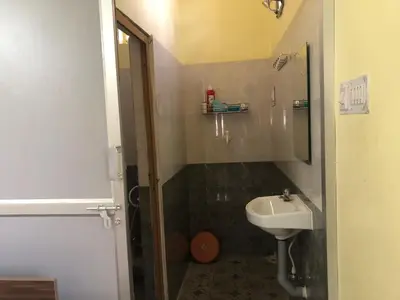 a bathroom with a sink and a toilet and a shower at A Sweet home Homestay Second Floor in Palani