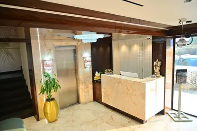 a lobby with a desk with a laptop on it at Hotel Golden Riviera in Mysore