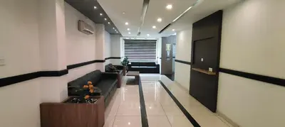 a hallway with a couch and a table in a building at HOTEL AL AMANA TOWER in Kondotti