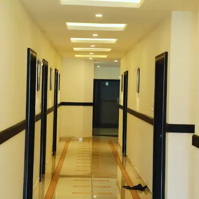 an empty hallway with doors and a hallway sidx sidx at HOTEL AL AMANA TOWER in Kondotti