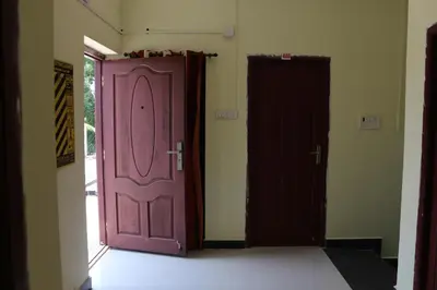 two doors are open in a room at Shree SaiRenu near maruthamalai and bharathiyar univ and on the way to Adiyogi Isha Yoga centre in Marudhamalai