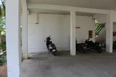 a garage with two motorcycles parked in it at Shree SaiRenu near maruthamalai and bharathiyar univ and on the way to Adiyogi Isha Yoga centre in Marudhamalai