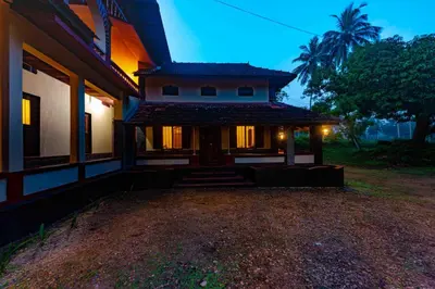 a house at night with the lights on at Vintage Vista in Lakkidi