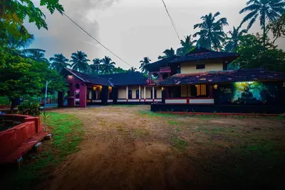 a house with a dirt road in front of it at Vintage Vista in Lakkidi