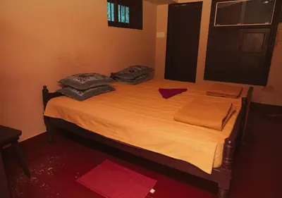 a bed with pillows on it in a room at Vintage Vista in Lakkidi